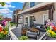Inviting front porch with ample seating, swing, stylish decor and flowers at 1832 W 33Rd Ave, Denver, CO 80211