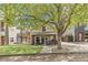 Charming exterior view of home with a large tree and inviting front porch seating area at 1832 W 33Rd Ave, Denver, CO 80211