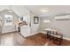 Compact kitchen with white cabinetry, stainless steel appliances, and a cozy dining area at 1832 W 33Rd Ave, Denver, CO 80211