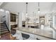 Stylish kitchen featuring an island, stainless steel appliances, and view of the staircase at 1832 W 33Rd Ave, Denver, CO 80211