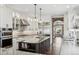 Elegant kitchen features a center island, stainless steel appliances, and custom cabinetry at 1832 W 33Rd Ave, Denver, CO 80211