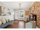 Stylish living room with hardwood floors, exposed brick wall, and natural light at 1832 W 33Rd Ave, Denver, CO 80211