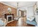 Open concept living room with brick fireplace, hardwood flooring, and natural light at 1832 W 33Rd Ave, Denver, CO 80211