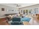 Open living room with dark wood floors, large sofa, stylish decor and lots of natural light at 1832 W 33Rd Ave, Denver, CO 80211
