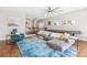 Bright living room with a large sectional, unique rug, ceiling fan and open floor plan at 1832 W 33Rd Ave, Denver, CO 80211