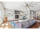 Spacious living room with fireplace, built-in shelves, large sectional and picture window at 1832 W 33Rd Ave, Denver, CO 80211