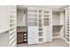 Spacious walk-in closet with custom white shelving, drawers, and hanging racks at 1832 W 33Rd Ave, Denver, CO 80211