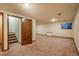 Spacious finished basement featuring carpeted floors, egress window, and neutral paint at 1585 W Briarwood Ave, Littleton, CO 80120