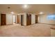 Large, open finished basement offers ample space and neutral carpeting at 1585 W Briarwood Ave, Littleton, CO 80120