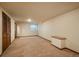 Spacious basement with carpet flooring, baseboard trim, and a small window with blinds at 1585 W Briarwood Ave, Littleton, CO 80120