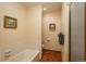 Cozy bathroom features a shower/tub combination with tile surround, and wood-look flooring at 1585 W Briarwood Ave, Littleton, CO 80120