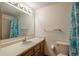 Well-lit bathroom with a large mirror, functional sink, and a tub/shower combo at 1585 W Briarwood Ave, Littleton, CO 80120
