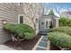 Landscaped front entrance featuring stone pavers, pea gravel and mature shrubbery at 1585 W Briarwood Ave, Littleton, CO 80120