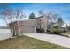 Two story home featuring a stone facade, neutral toned wood siding, and an attached two car garage at 1585 W Briarwood Ave, Littleton, CO 80120