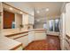 Bright kitchen featuring white cabinets, tile countertops and hardwood floors at 1585 W Briarwood Ave, Littleton, CO 80120