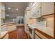 Bright kitchen featuring white cabinets, tile countertops, and stainless steel appliances at 1585 W Briarwood Ave, Littleton, CO 80120