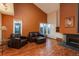 Cozy living room features wood floors, large windows, a fireplace, and comfortable leather seating at 1585 W Briarwood Ave, Littleton, CO 80120