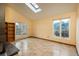 Spacious living room with skylight, French doors, and large windows for ample natural light at 1585 W Briarwood Ave, Littleton, CO 80120
