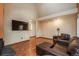 Open-concept living room with vaulted ceilings, wood floors, and a cozy seating area at 1585 W Briarwood Ave, Littleton, CO 80120