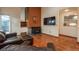 Warm living room with wood floors, a fireplace, comfortable seating, and a view outside at 1585 W Briarwood Ave, Littleton, CO 80120