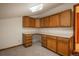 Room featuring built-in wood cabinets, drawers, and white countertops against white walls at 1585 W Briarwood Ave, Littleton, CO 80120