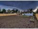 Large fenced backyard with patio, garden boxes, and a view of the house at 40 Benton St, Lakewood, CO 80226