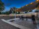 Backyard with covered patio, outdoor seating, and barbecue grill overlooking the fenced yard at 40 Benton St, Lakewood, CO 80226