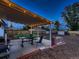 Covered backyard patio features outdoor dining set, barbecue grill, and well-maintained landscaping at 40 Benton St, Lakewood, CO 80226