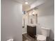 Minimalist bathroom featuring modern fixtures, a vanity with dark cabinets, and a tiled shower for a clean and contemporary look at 40 Benton St, Lakewood, CO 80226
