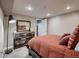 Well-lit bedroom featuring rustic furniture, a cozy bed, and a view of the room reflected on a mirror on top of the dresser at 40 Benton St, Lakewood, CO 80226