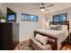 Comfortable bedroom with a wooden bed frame, cozy linens, and view outside the window that lets in a lot of natural light at 40 Benton St, Lakewood, CO 80226