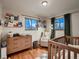 Charming Bedroom featuring a cozy crib, a comfortable rocking chair, and plenty of storage for books and baby essentials at 40 Benton St, Lakewood, CO 80226