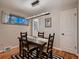 This is a cozy dining room features a dark wood table, modern light fixture and neutral color scheme at 40 Benton St, Lakewood, CO 80226