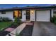 Close-up of the front yard and brick entry of this home with a contemporary front door at 40 Benton St, Lakewood, CO 80226