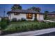 Charming single-story home with manicured lawn and flower beds. Features include attached garage and inviting entryway at 40 Benton St, Lakewood, CO 80226