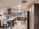 This kitchen features stainless appliances, tile floors, and custom cabinets with a modern aesthetic at 40 Benton St, Lakewood, CO 80226