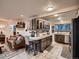 Open-concept kitchen features custom cabinetry, stainless steel appliances, and breakfast bar seating with tile floors at 40 Benton St, Lakewood, CO 80226