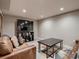 Well-lit living room with a comfortable leather couch, a large TV, and a modern coffee table perfect for relaxing and entertaining at 40 Benton St, Lakewood, CO 80226