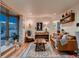 Comfortable living room featuring stylish decor, hardwood flooring, and large windows at 40 Benton St, Lakewood, CO 80226
