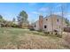 Spacious yard with trees and a view of the home's exterior, including a brick chimney at 5603 S Pagosa Ct, Centennial, CO 80015