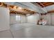 Spacious unfinished basement with exposed ceiling and concrete walls and floors at 5603 S Pagosa Ct, Centennial, CO 80015