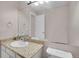 Bright bathroom featuring a granite countertop, a large mirror, and neutral decor at 5603 S Pagosa Ct, Centennial, CO 80015