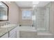 Bright bathroom featuring granite countertops, soaking tub, and glass shower with a window at 5603 S Pagosa Ct, Centennial, CO 80015
