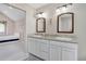Bathroom with dual vanity sinks, granite countertop, white cabinets, and an adjoined bedroom at 5603 S Pagosa Ct, Centennial, CO 80015
