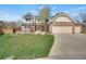Inviting two-story brick home featuring a well-maintained front lawn and an attached three-car garage at 5603 S Pagosa Ct, Centennial, CO 80015