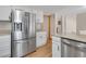 Modern kitchen featuring stainless steel appliances, granite countertops, and white cabinets at 5603 S Pagosa Ct, Centennial, CO 80015