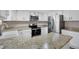 Bright kitchen showcasing granite countertops, stainless steel appliances, and sleek white cabinetry at 5603 S Pagosa Ct, Centennial, CO 80015