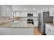 Eat-in kitchen features stainless steel appliances, bright white cabinets, and granite countertops at 5603 S Pagosa Ct, Centennial, CO 80015