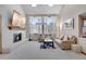 Inviting living room with a white brick fireplace and large windows with sheer curtains at 5603 S Pagosa Ct, Centennial, CO 80015