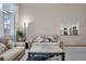 Cozy living room featuring plush seating and a view into the adjacent kitchen at 5603 S Pagosa Ct, Centennial, CO 80015